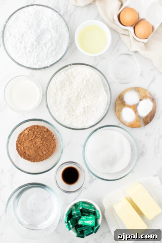 Assortment of baking ingredients including sugar, flour, eggs, cocoa, butter, milk, vanilla, and food coloring, artfully arranged in bowls on a table, ready for baking.