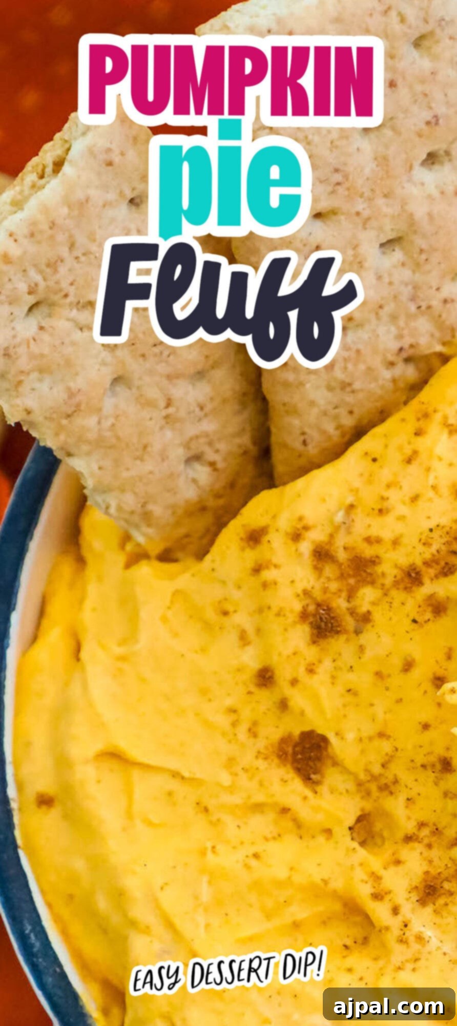 Creamy Pumpkin Dream 9 cool whip pumpkin pie fluff in a white bowl with graham crackers in it