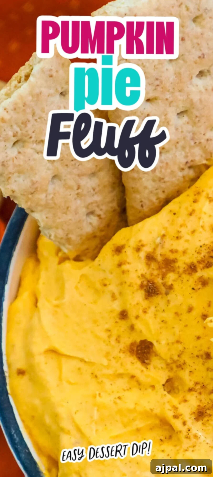 cool whip pumpkin pie fluff in a white bowl with graham crackers in it