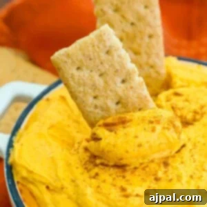 cool whip pumpkin pie fluff in a white bowl with graham crackers in it