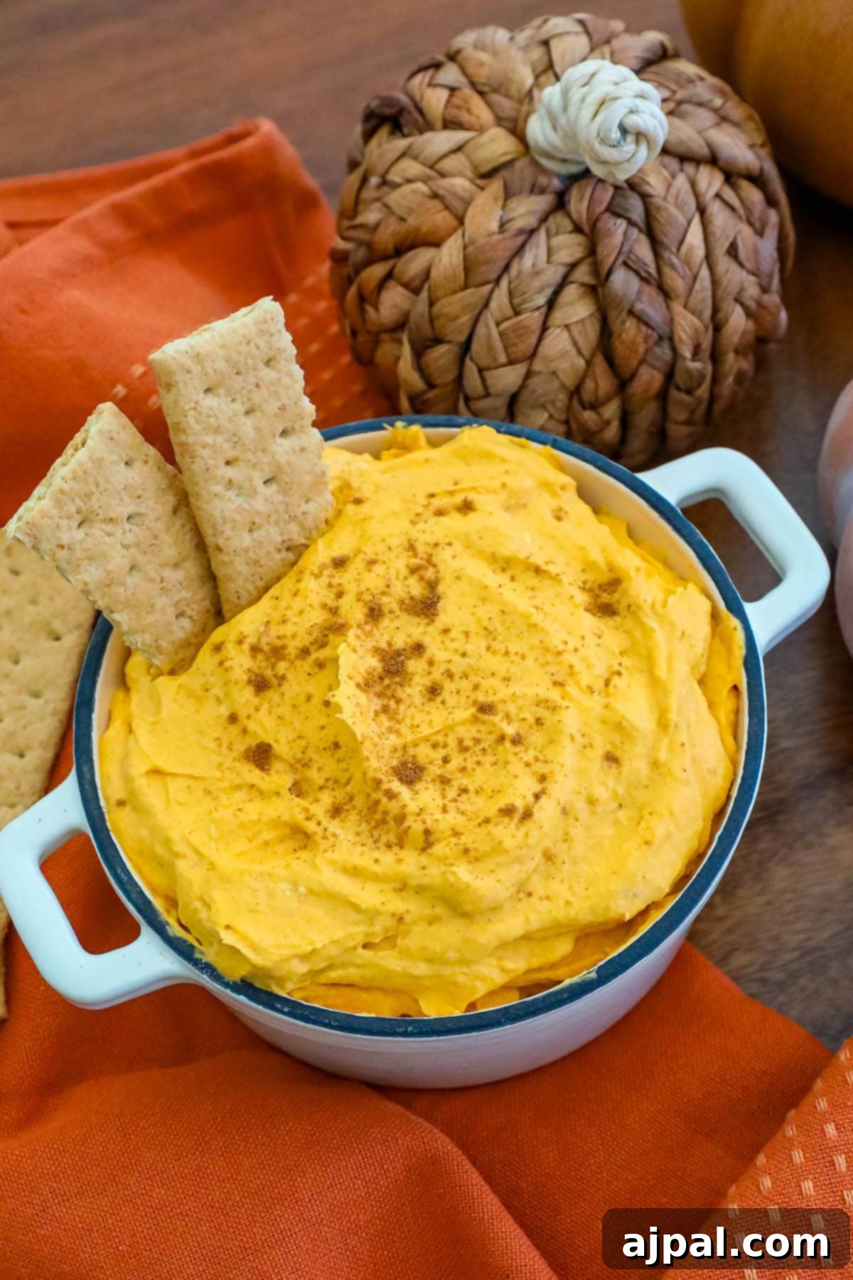 cool whip pumpkin pie fluff in a white bowl with graham crackers in it