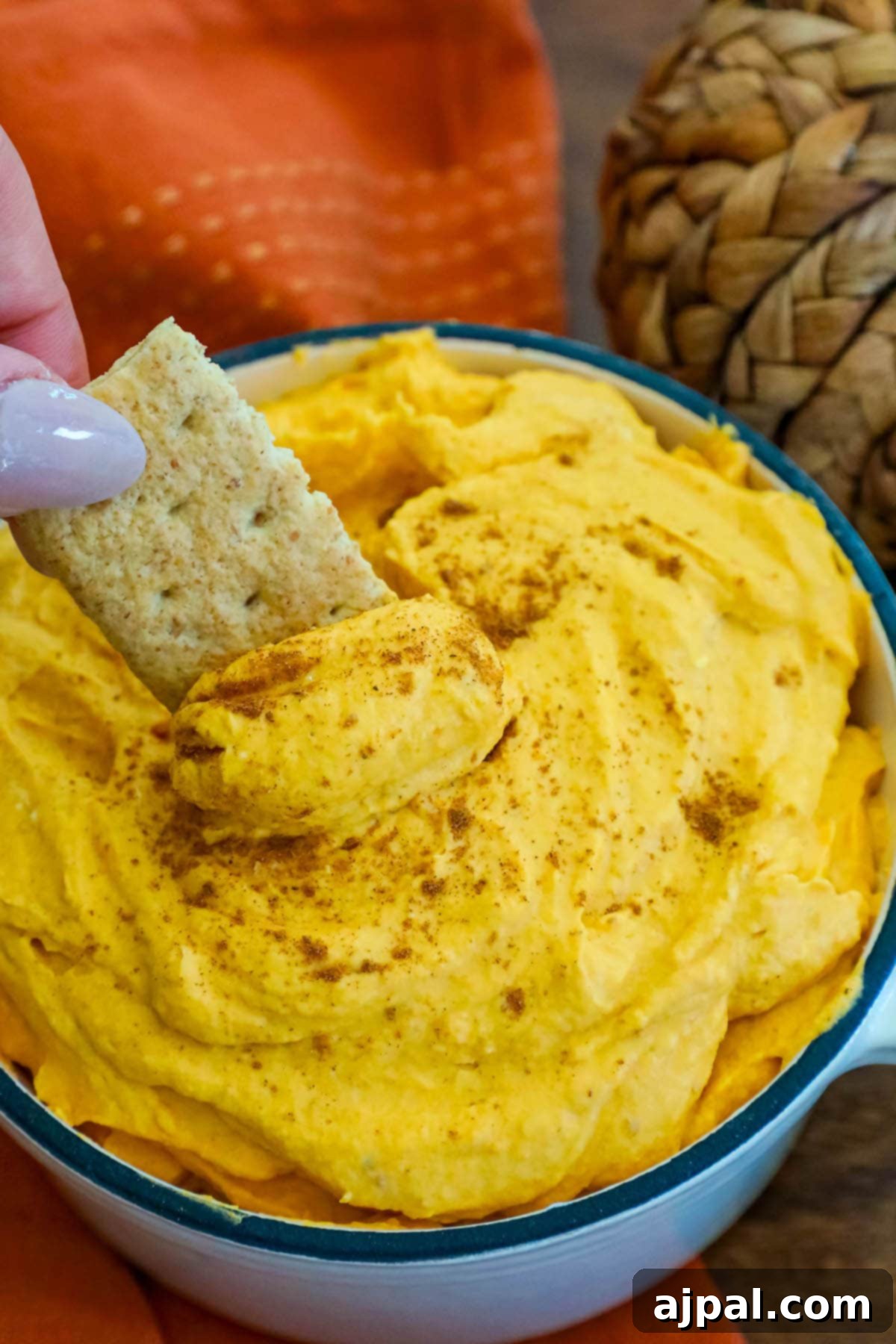 cool whip pumpkin pie fluff in a white bowl with graham crackers in it