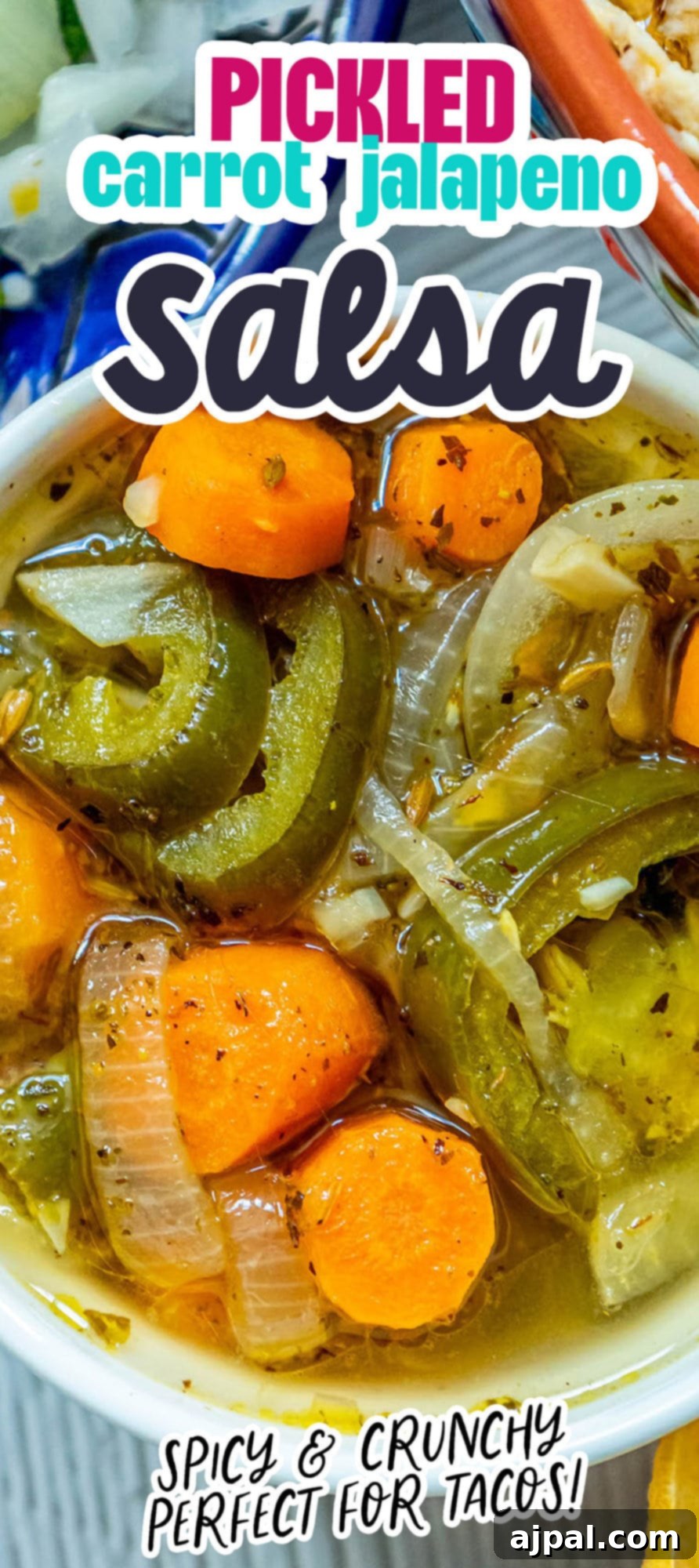 Zesty Carrot Jalapeno Relish 12 a bowl of pickled sliced carrots and jalapenos with onion slices on a table