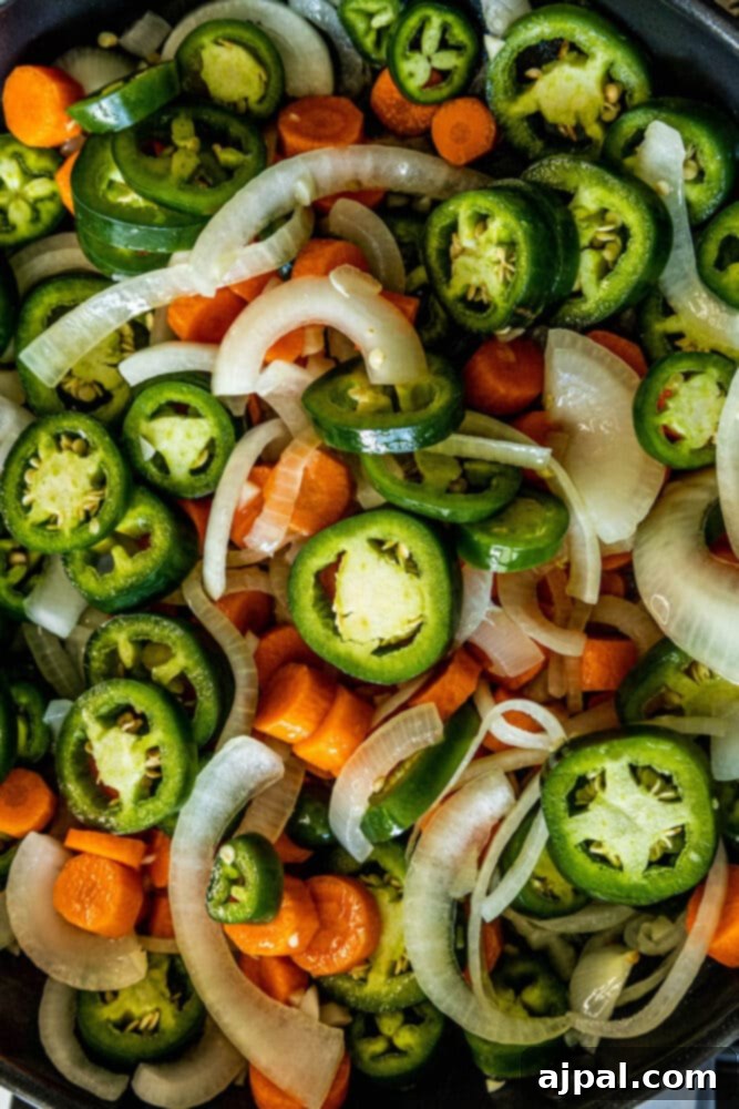 Zesty Carrot Jalapeno Relish 6 a pan with sliced jalapenos, carrots, and onions in it