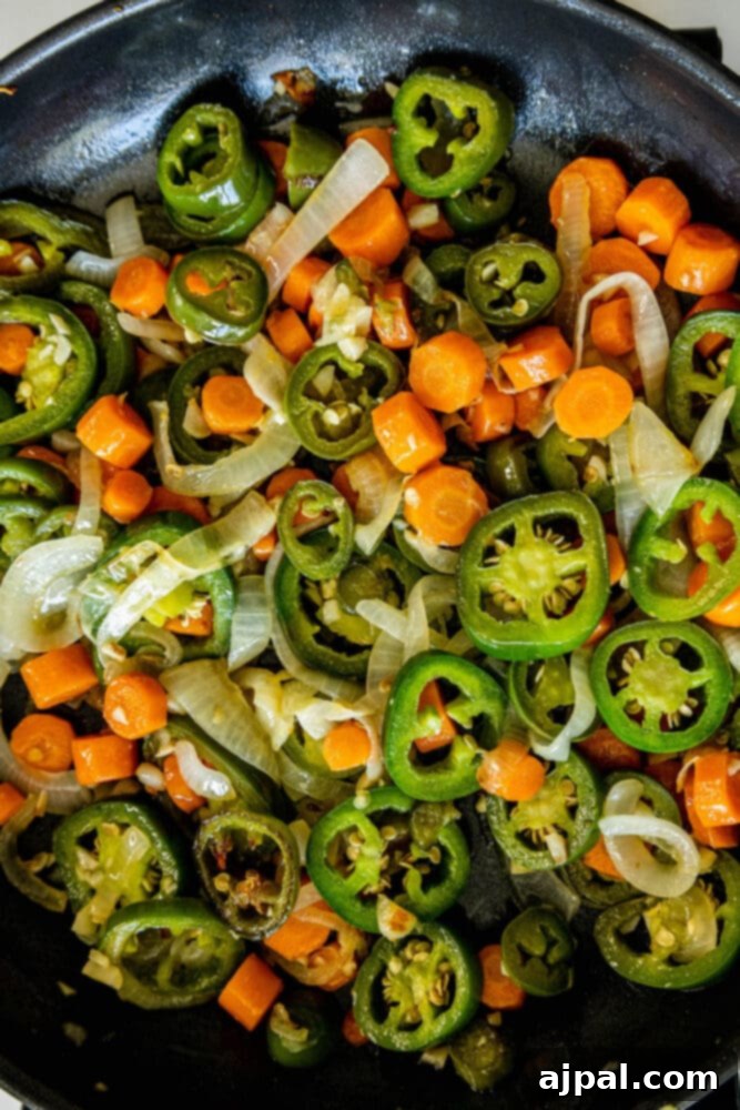 Zesty Carrot Jalapeno Relish 7 a pan with browned sliced carrots, onions, and jalapenos in it