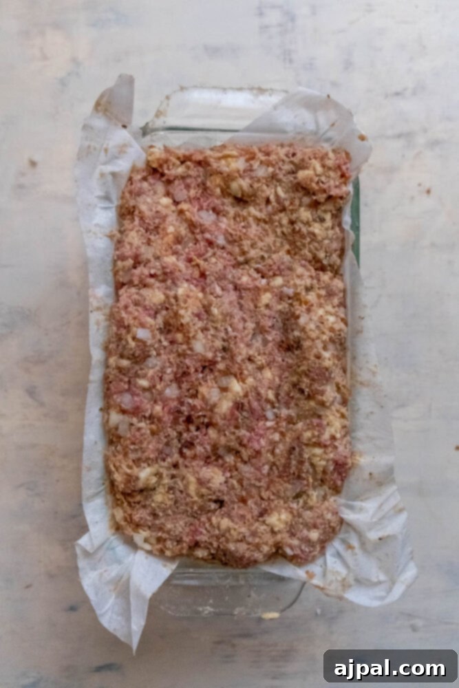 meatloaf in a loaf pan lined with parchment paper