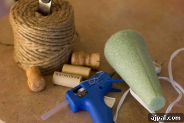 Detailed view of wine corks and a hot glue gun, ready for crafting a Christmas tree.