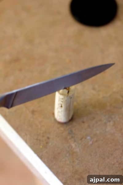 Demonstration of how to safely cut wine corks in half for the DIY Christmas tree project.