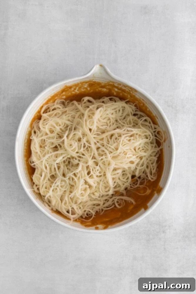 Kickin' Peanut Noodles 6 Freshly cooked thin Thai noodles are delicately placed into a bowl of rich peanut sauce, ready to be tossed and coated.