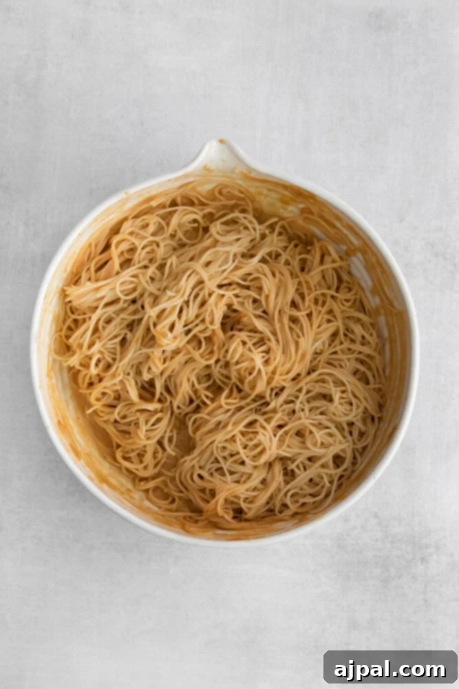 Kickin' Peanut Noodles 7 Cooked Thai noodles, glistening with a generous coating of rich, spicy peanut sauce, are ready for the next delicious additions.