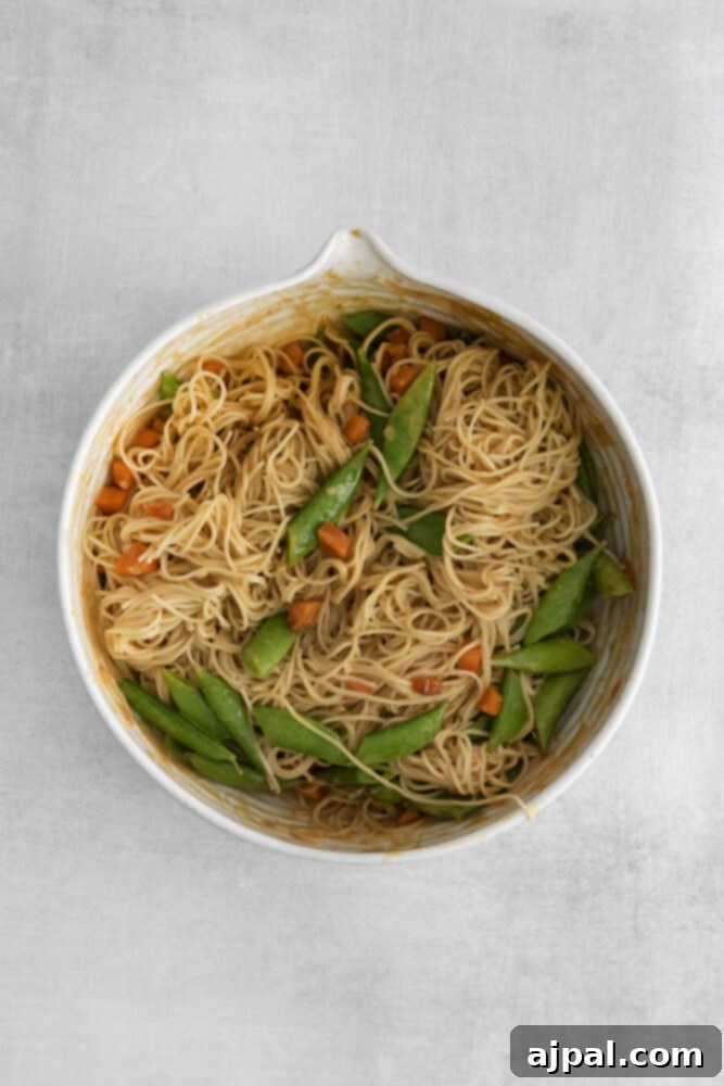 The spicy peanut noodles with snap peas and carrots fully mixed and ready to serve.