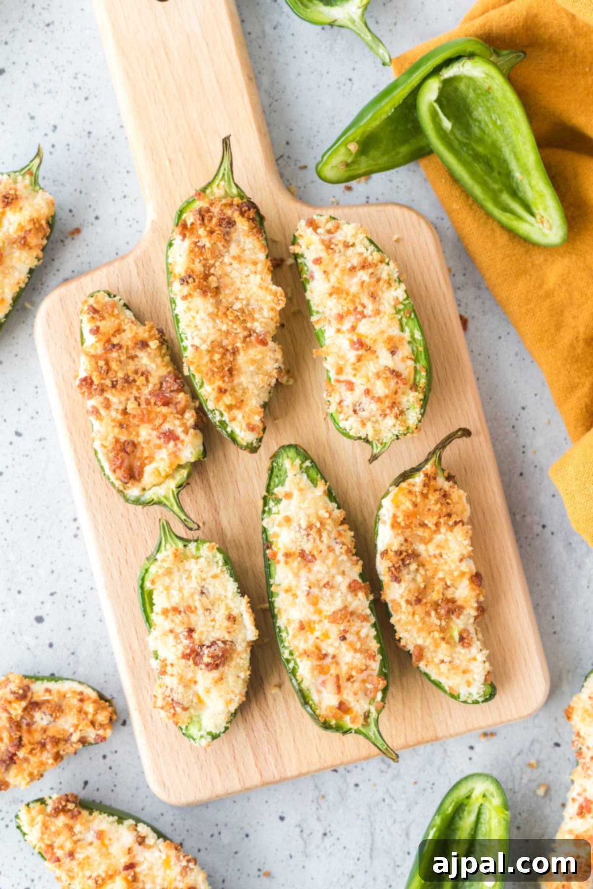 A close-up shot of perfectly air-fried jalapeño poppers, golden brown and crispy, with their creamy cheese filling and panko breadcrumb topping visible.
