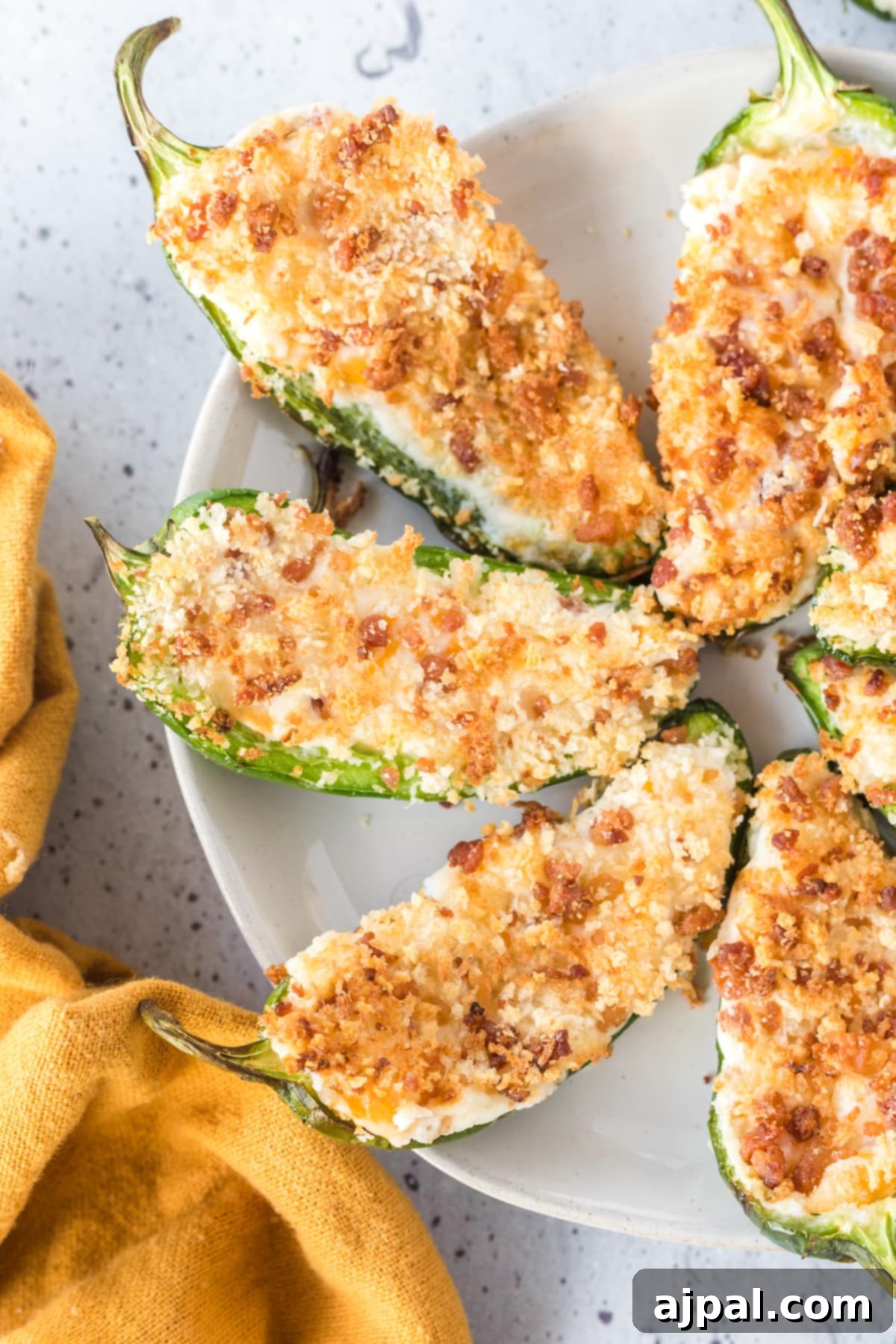 A close-up of beautifully air-fried jalapeño poppers, stuffed with a creamy cheese mixture and topped with crispy panko, ready to be enjoyed.
