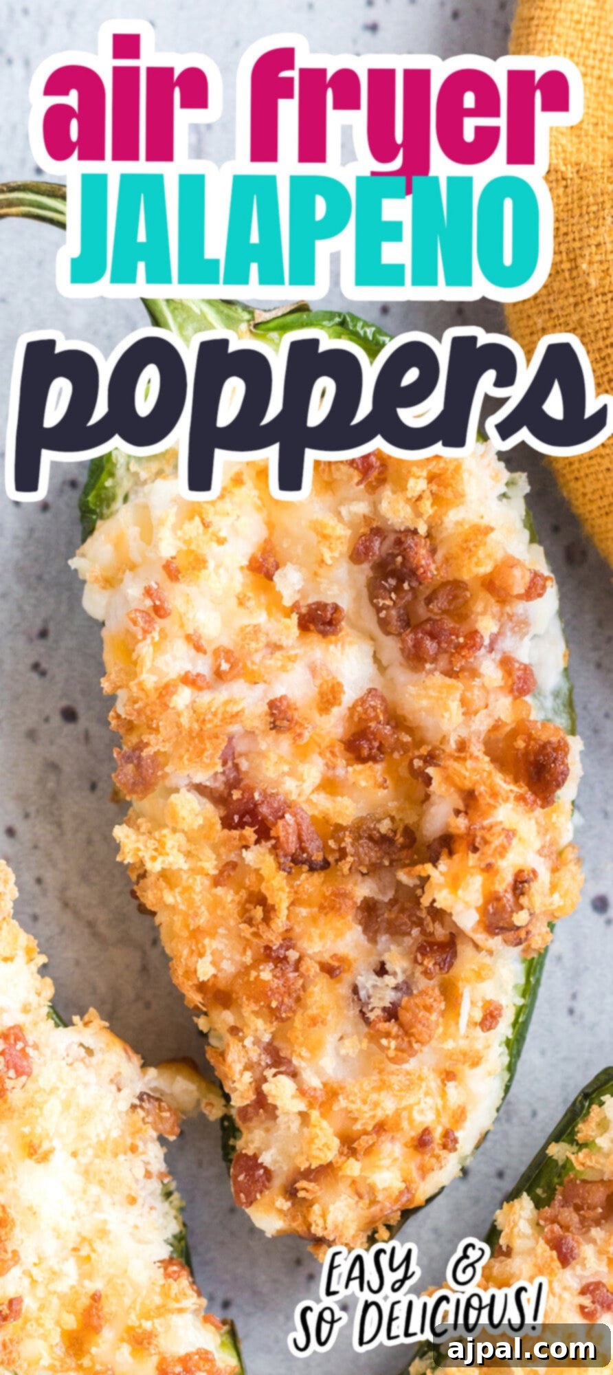A perfectly air-fried jalapeño popper, sliced in half to showcase its creamy, cheesy interior and crispy golden-brown topping, artfully arranged on a plate.