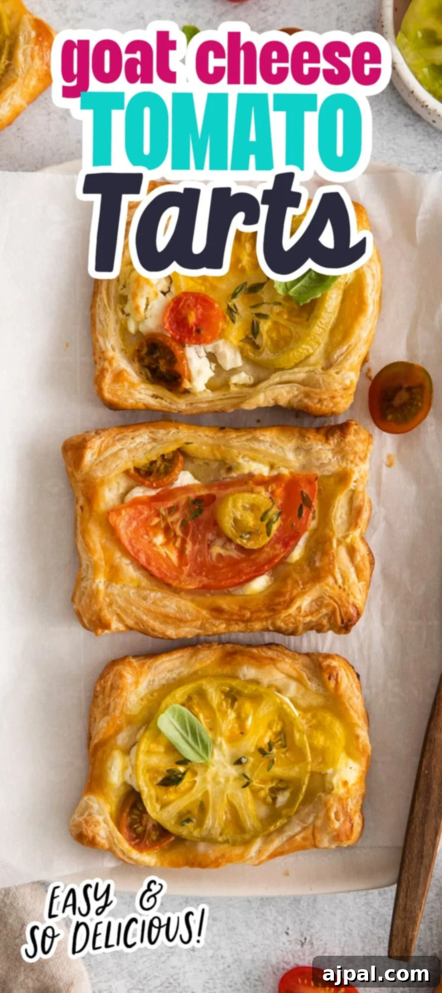 Tomato Goat Cheese Tarts 12 A stunning vertical image showcasing a close-up of the finished goat cheese and tomato tarts, perfectly golden and garnished with fresh herbs, ideal for pinning or sharing.
