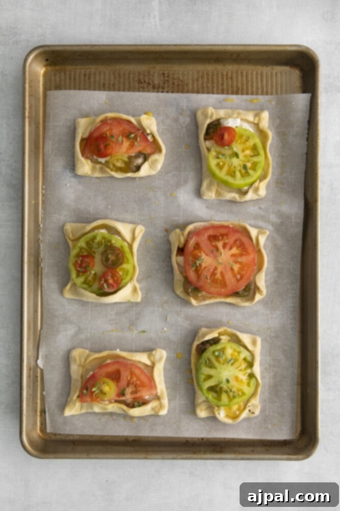 Tomato Goat Cheese Tarts 8 The puff pastry edges are folded over to create a slight border around the goat cheese and tomato filling, forming elegant 'boats'.
