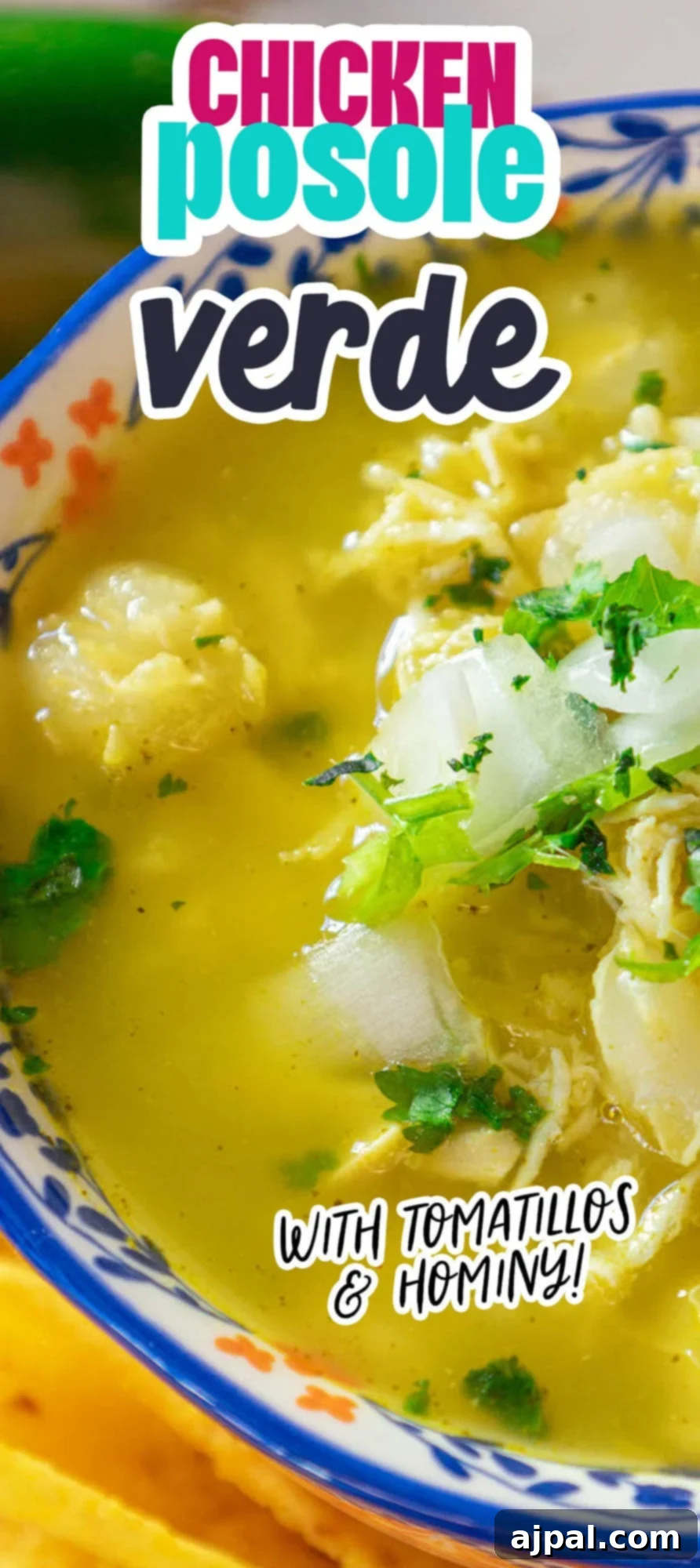 green shredded chicken posole in a bowl with cilantro and onion