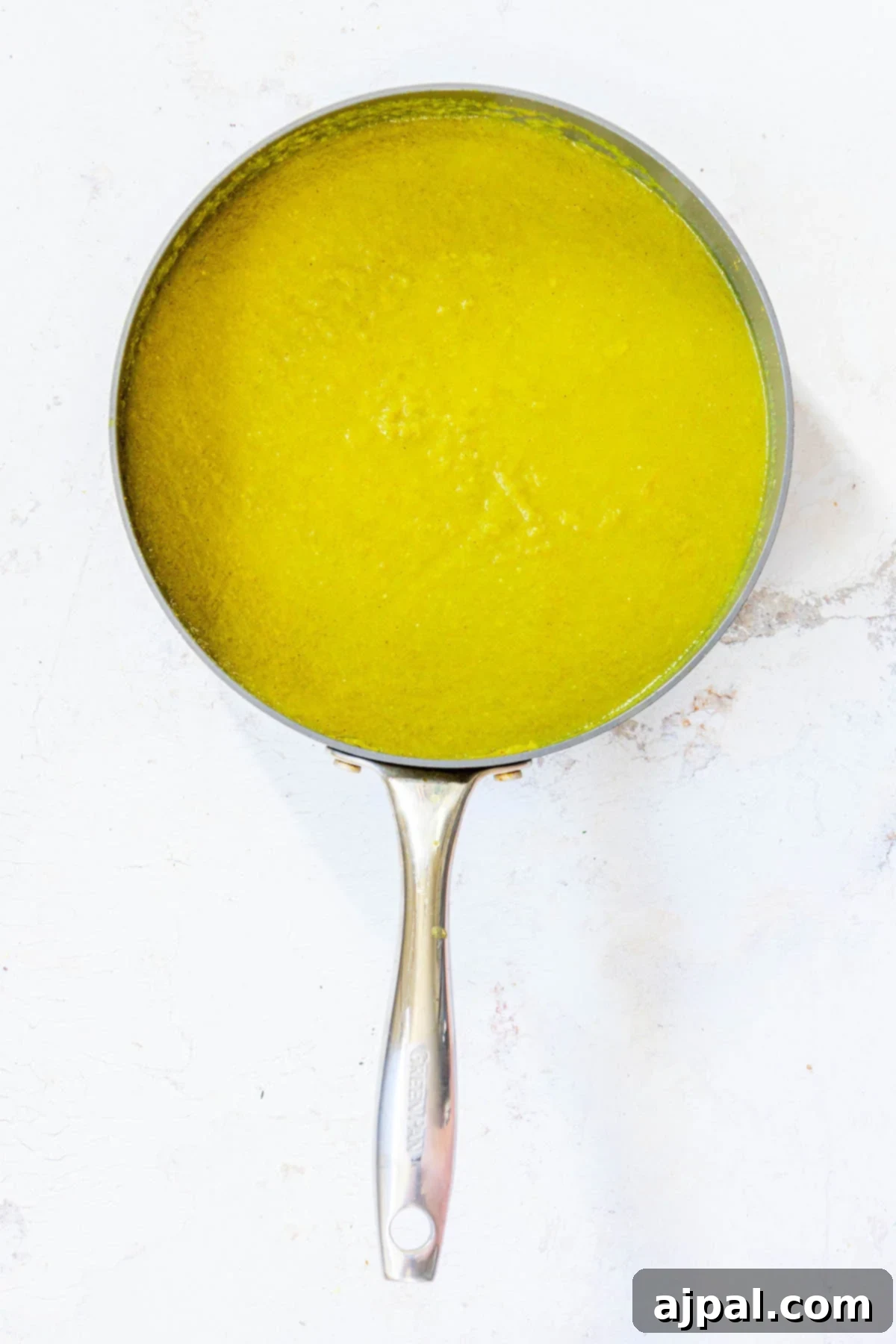 cooked posole green sauce in a pan