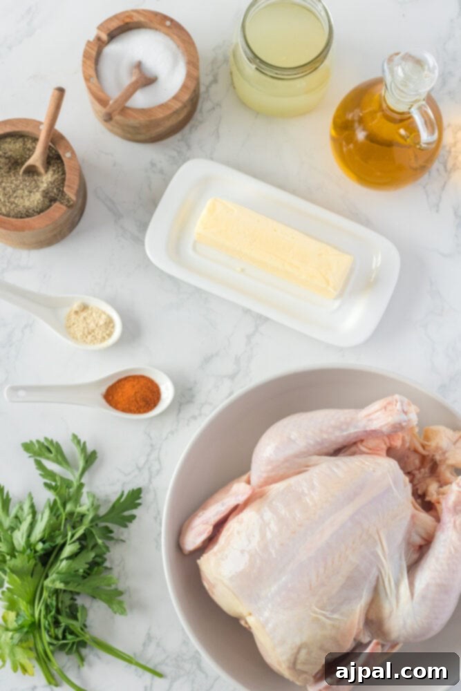 Chicken, butter, oil, and stock laid out on a table, ready for cooking a whole chicken in an Instant Pot.