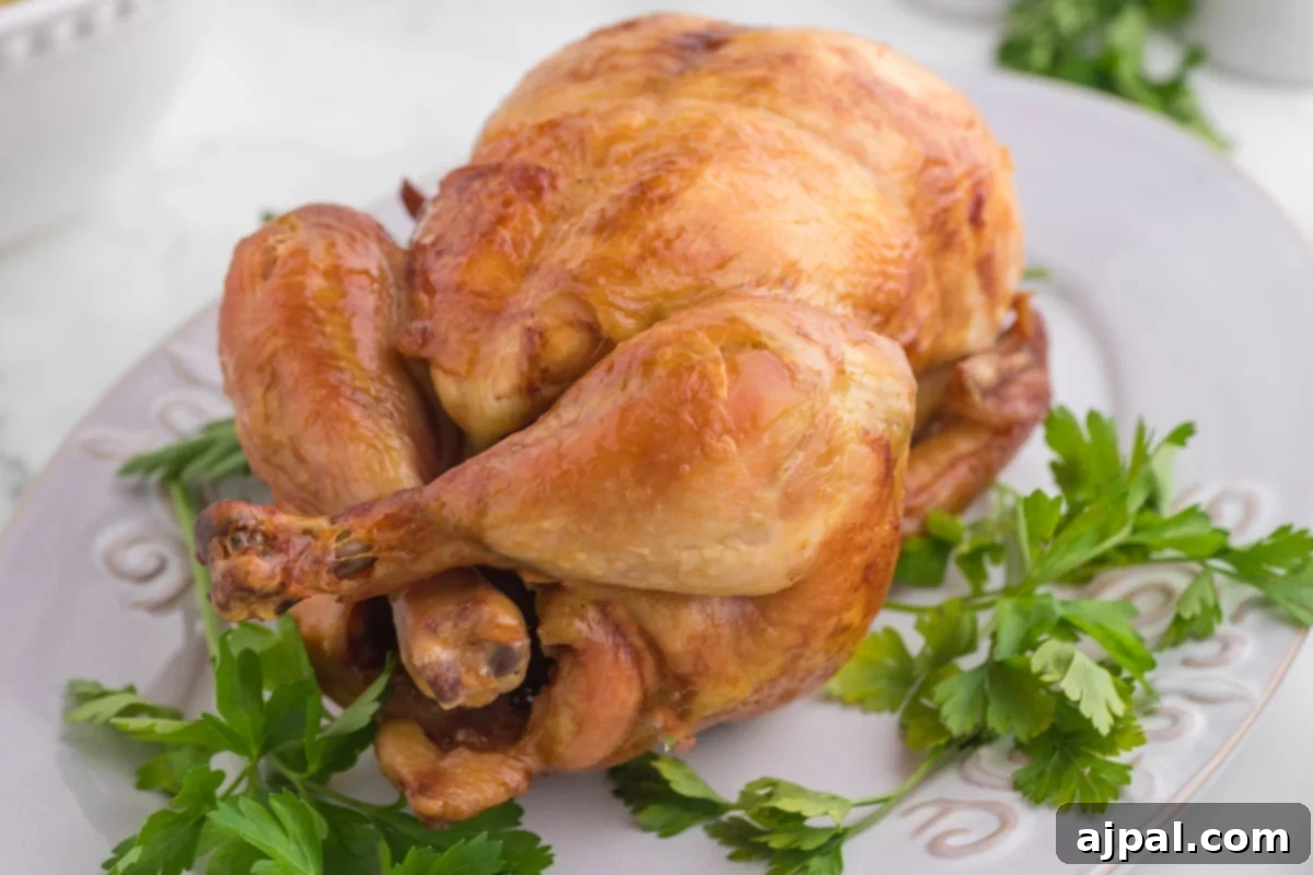 Perfect Instant Pot Whole Chicken 10 roasted whole chicken on a white plate with peas and mashed potatoes in front of an instant pot