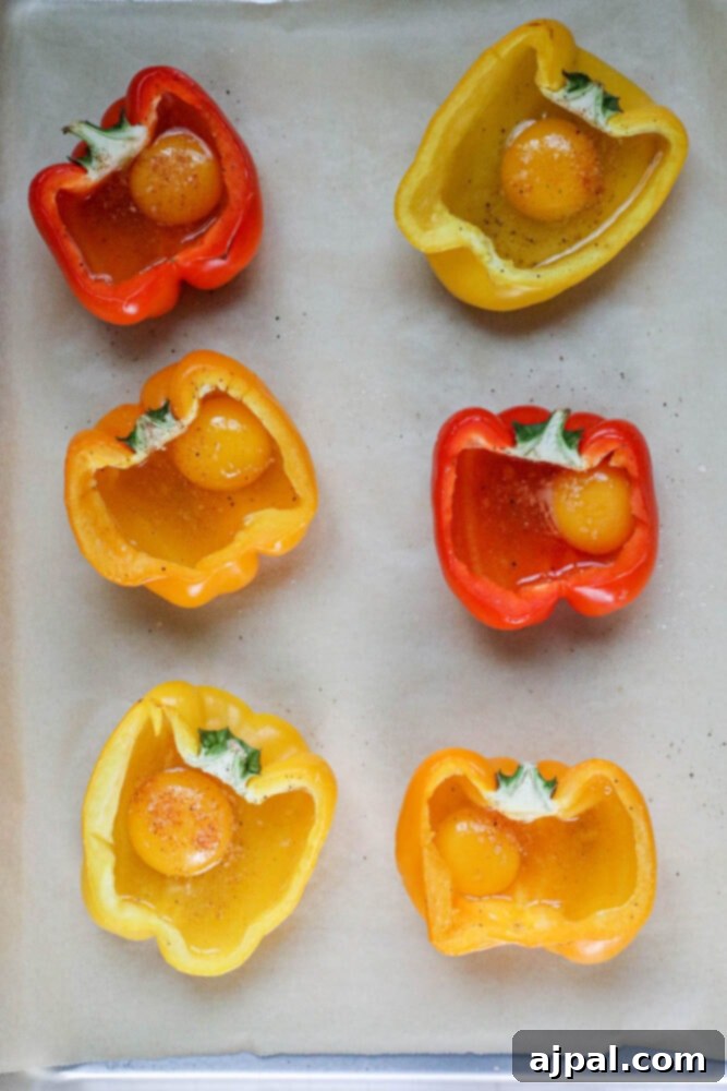 Bell Pepper Egg Bake 6 egg in a halved bell pepper on a baking sheet