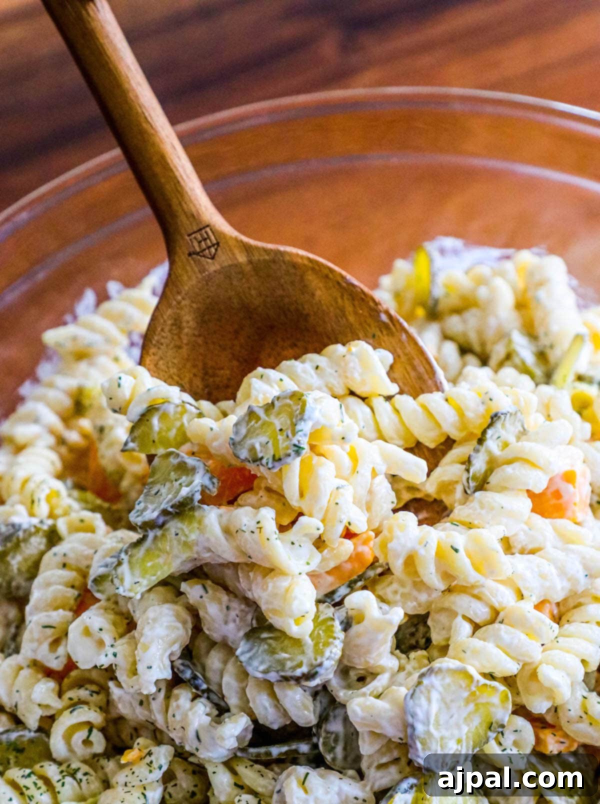 Tangy Dill Pasta Delight 2 A vibrant bowl of dill pickle pasta salad, showcasing chunks of pickles, pasta, and a creamy dressing, ready to be served.