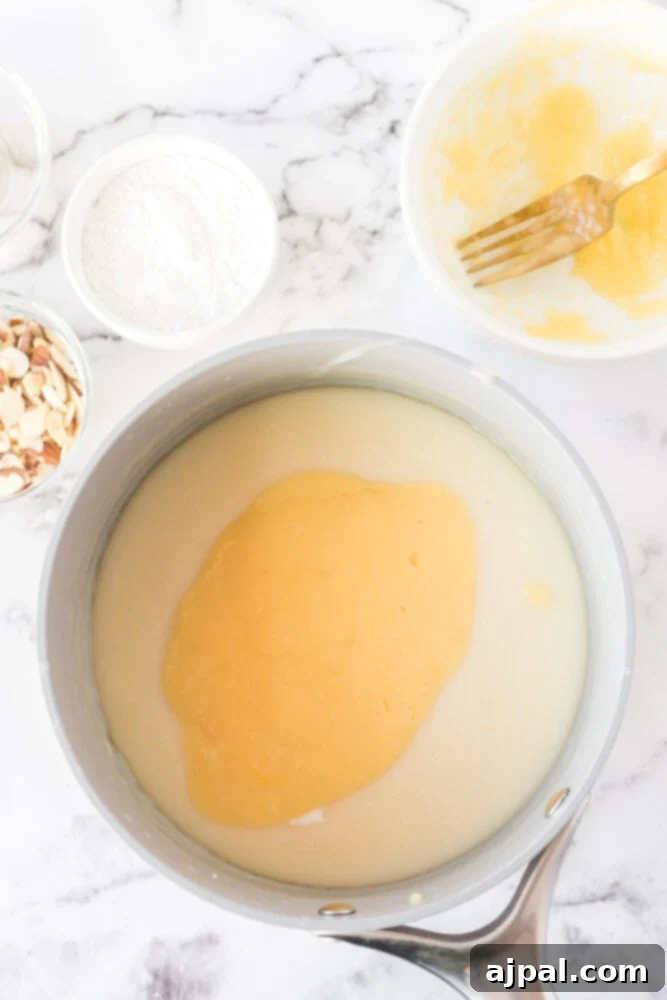 Creamy Banana Delight 10 custard being mixed with egg and butter in a bowl