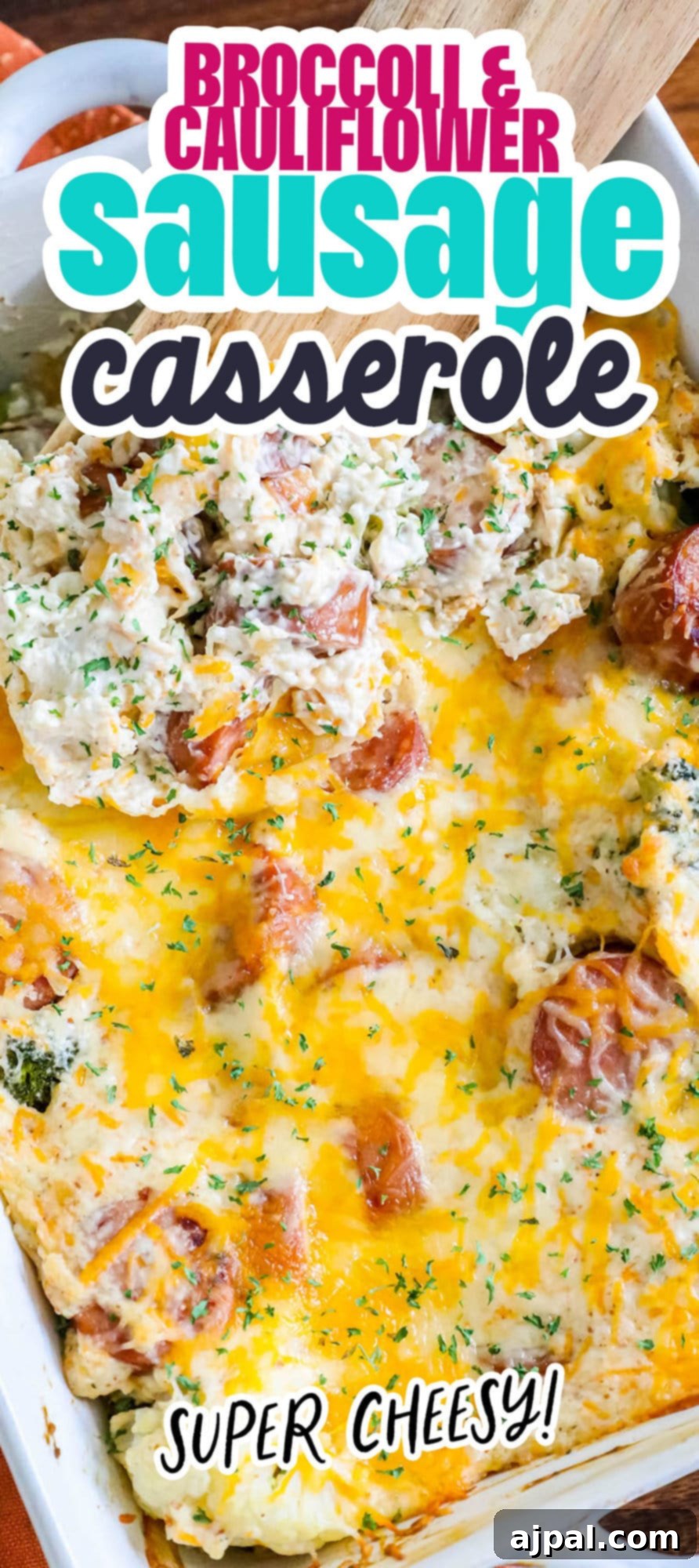 A wooden spoon serving a portion of freshly baked cheesy broccoli cauliflower sausage casserole, showcasing the rich texture and delicious ingredients.