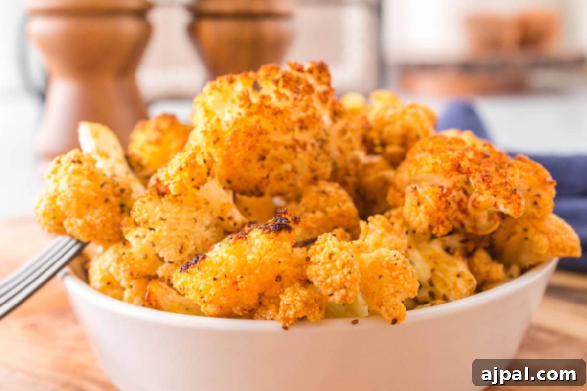 browned seasoned cauliflower in a white bowl