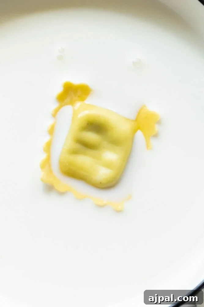 Ravioli being dipped into a bowl of milk