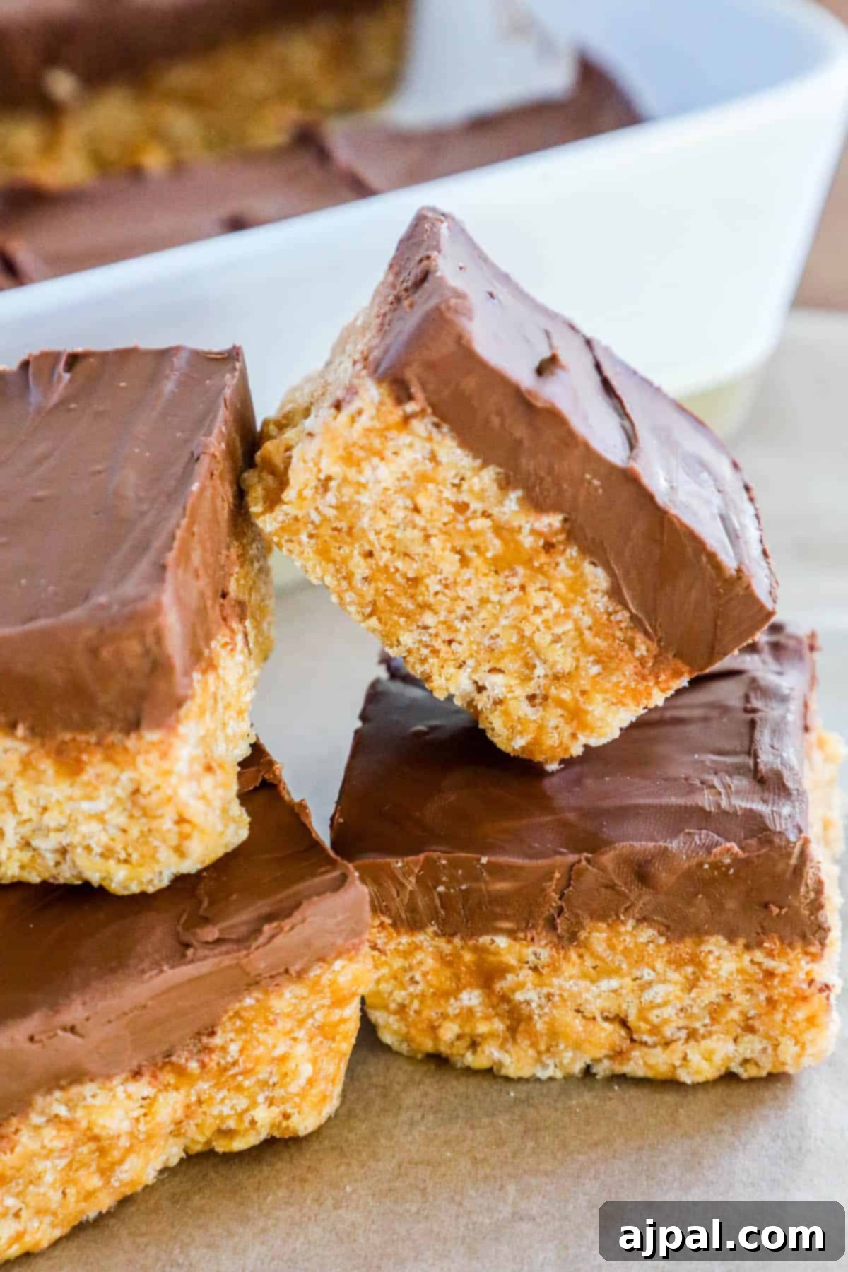 A stack of scotcheroos on a baking sheet.