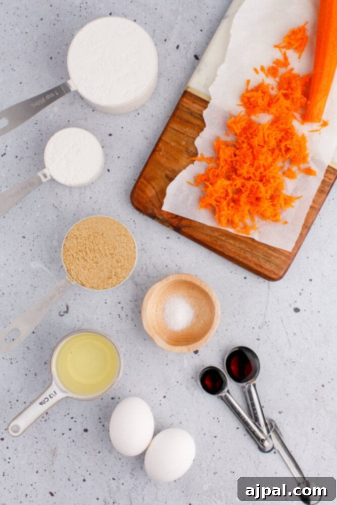 Effortless Carrot Muffins 5 Assorted muffin ingredients laid out on a table: shredded carrots, milk, eggs, vanilla, flour, and oil in various cups and bowls.