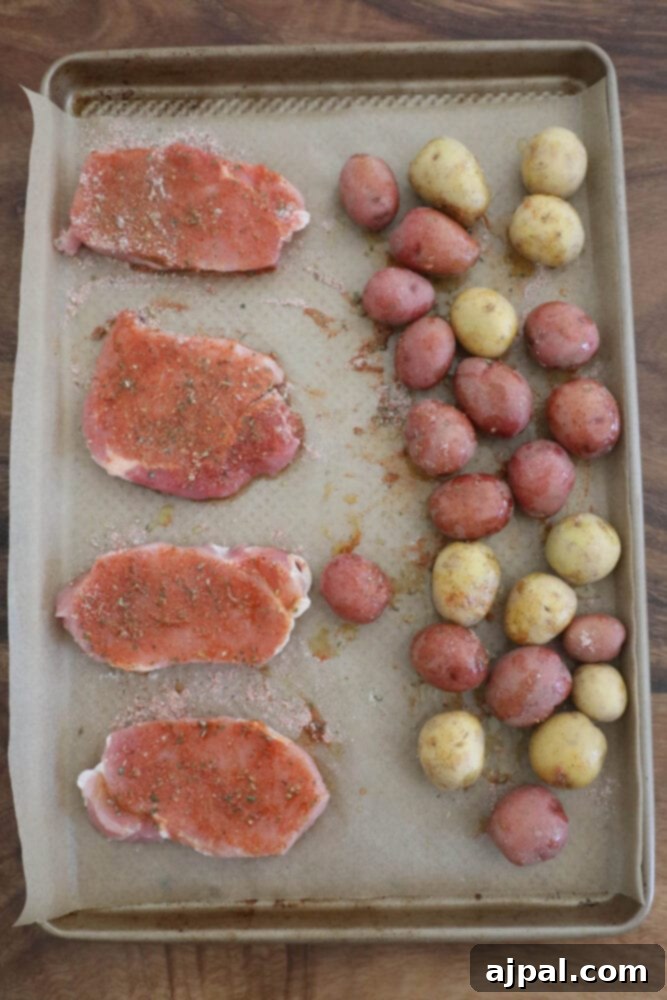 Zesty Ranch Pork Chops and Roasted Potatoes 5 Easy one pot dinner: Ranch pork chops and potatoes on a baking sheet.