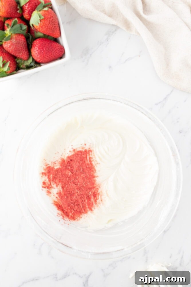 Fresh Strawberry Layer Cake 13 freeze dried strawberries in whipped icing in a bowl