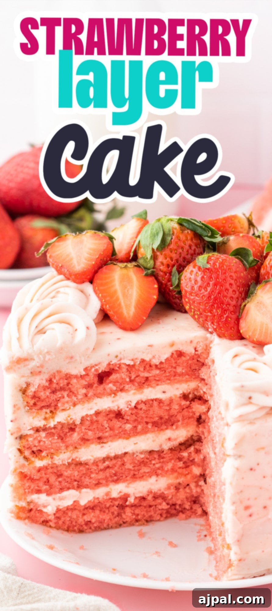 Fresh Strawberry Layer Cake 18 fresh sliced strawberries on a pink frosted cake with layers of whipped pink icing that has strawberry bits in it