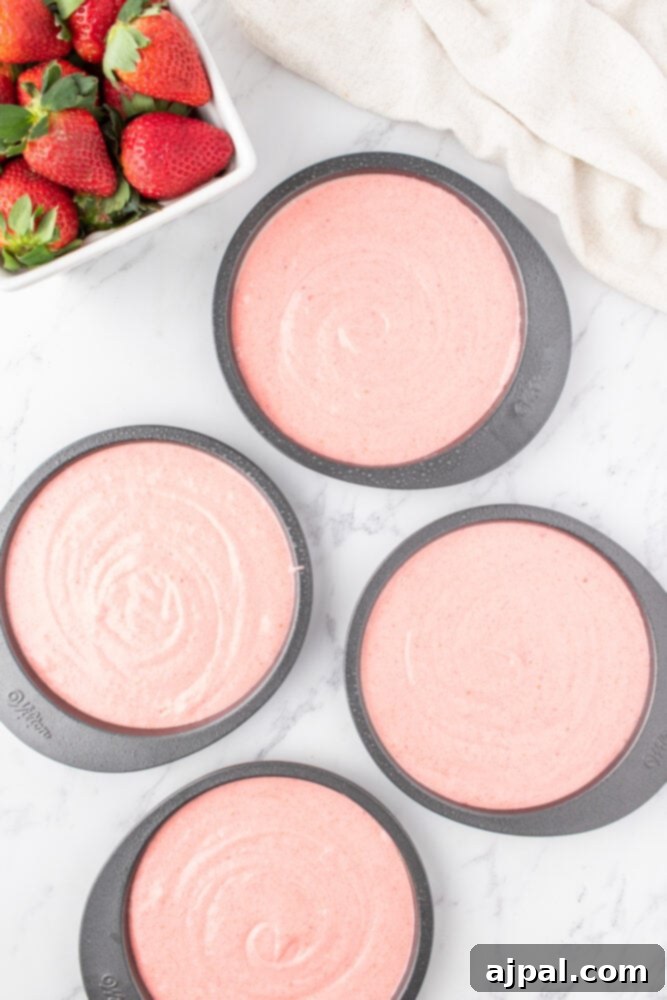 Fresh Strawberry Layer Cake 8 pink cake batter in layer cake pans on a table