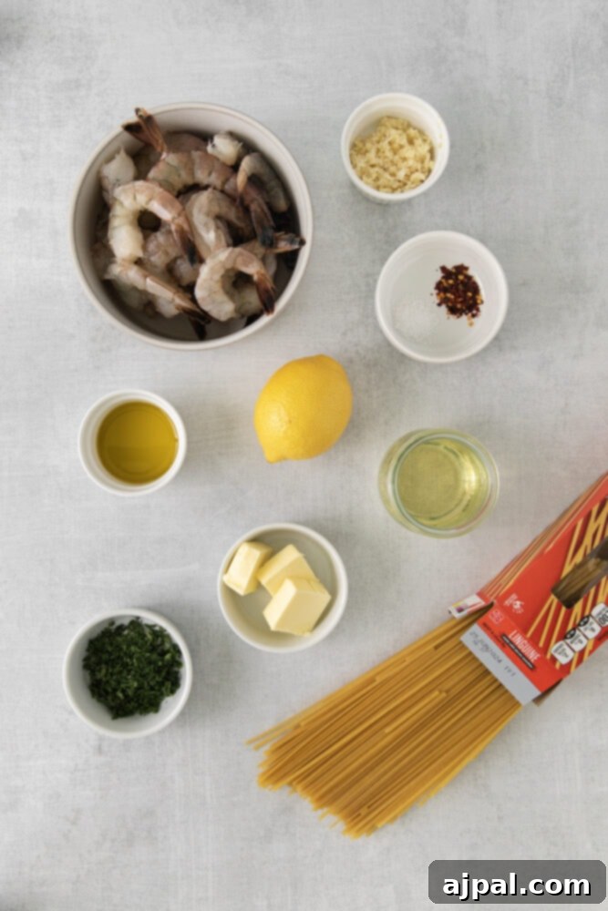 Effortless Shrimp Scampi 5 shrimp, lemon, oil, butter, wine, herbs, pasta, garlic, red pepper flakes on a table