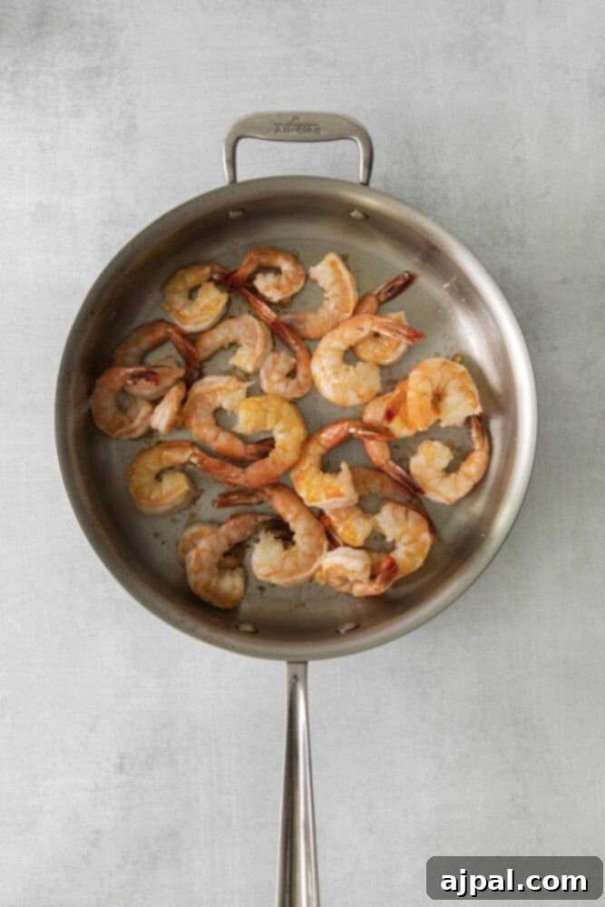Effortless Shrimp Scampi 6 sautéed shrimp in a pan with butter