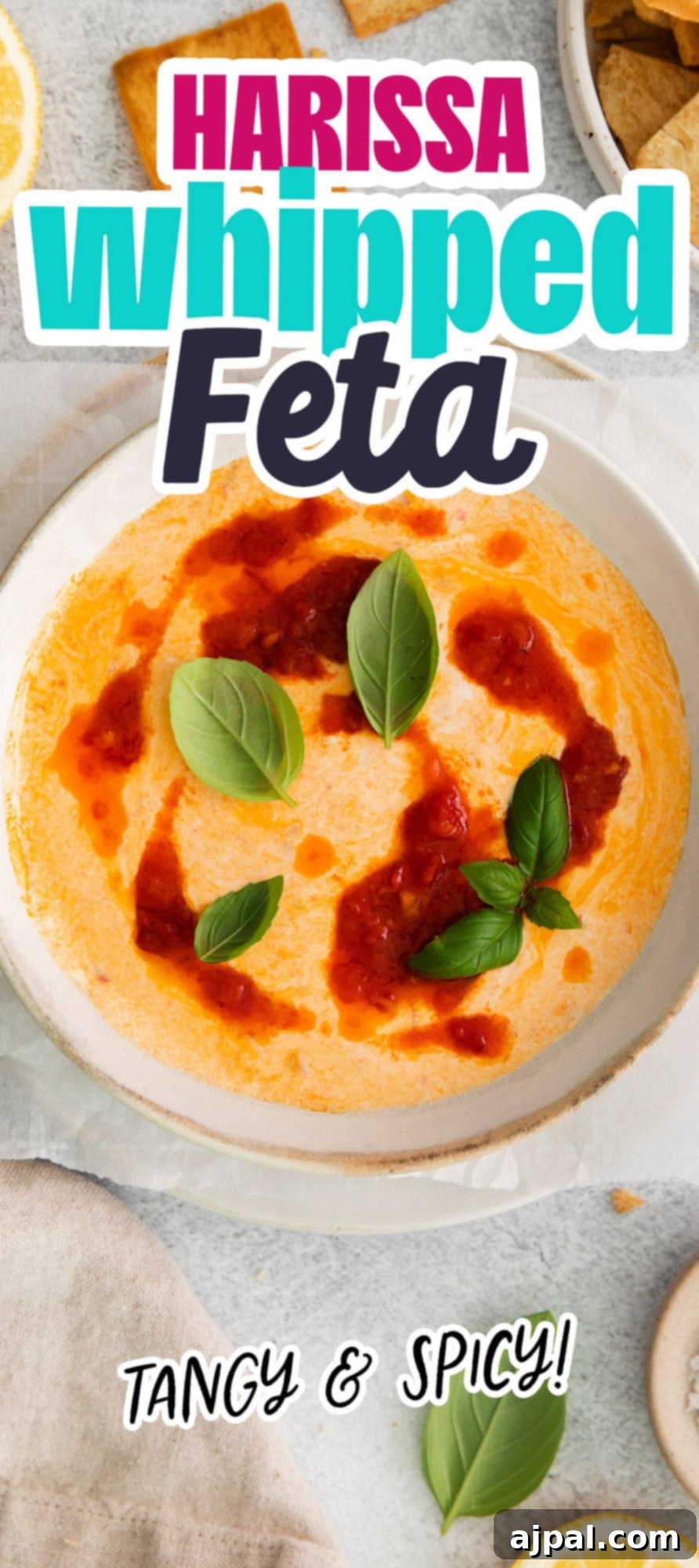 A vibrant bowl of spicy harissa whipped feta, elegantly garnished, showcasing its creamy texture and rich color.