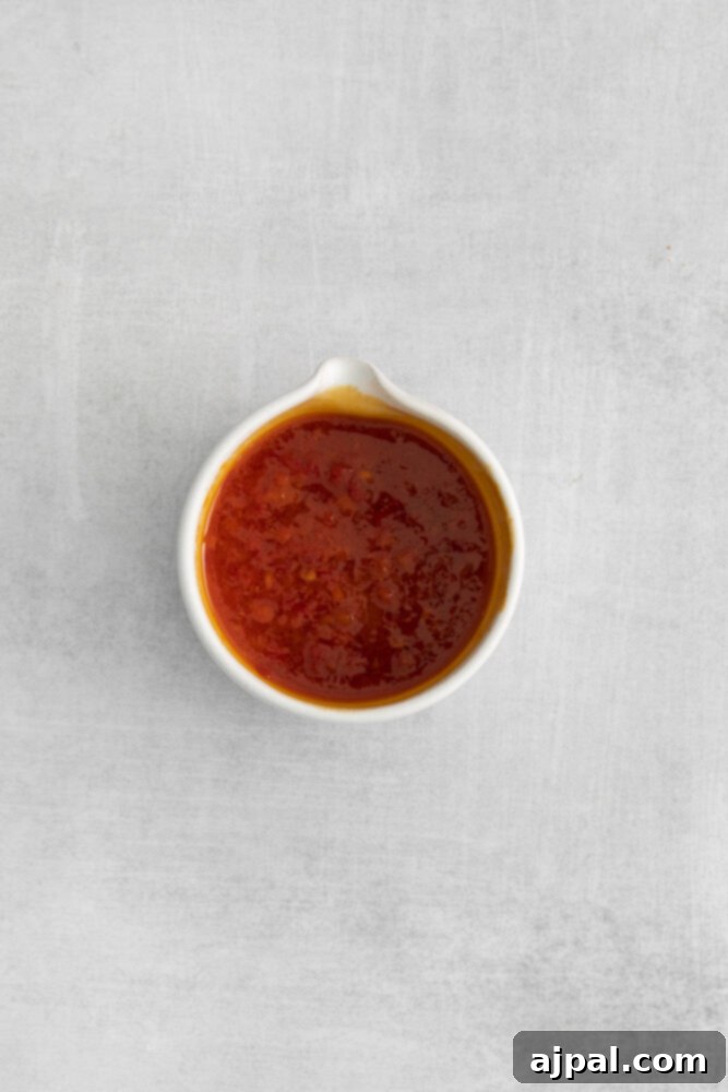 A small bowl filled with vibrant red harissa paste, the key ingredient for the spicy kick.