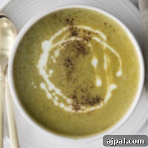 Velvety Instant Pot Asparagus Soup 12 asparagus soup in a white bowl with a swirl of cream on top and a crack of pepper