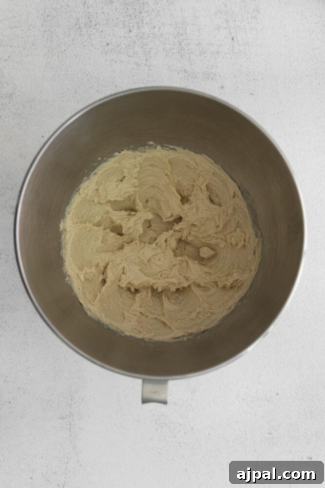 Golden Maple Pecan Biscotti 5 A metal mixing bowl containing creamed butter, light brown sugar, and maple syrup, ready for the next steps.