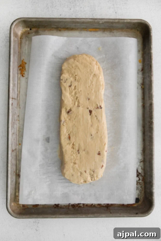 Artisan Maple Pecan Biscotti 7 A piece of pecan maple biscotti dough on a baking sheet