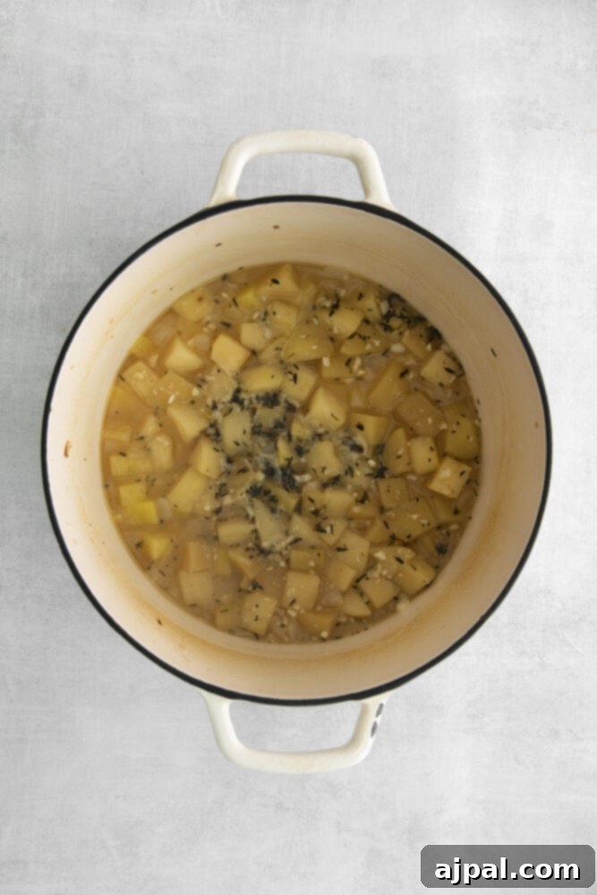 browned vegetables and stock in a dutch oven