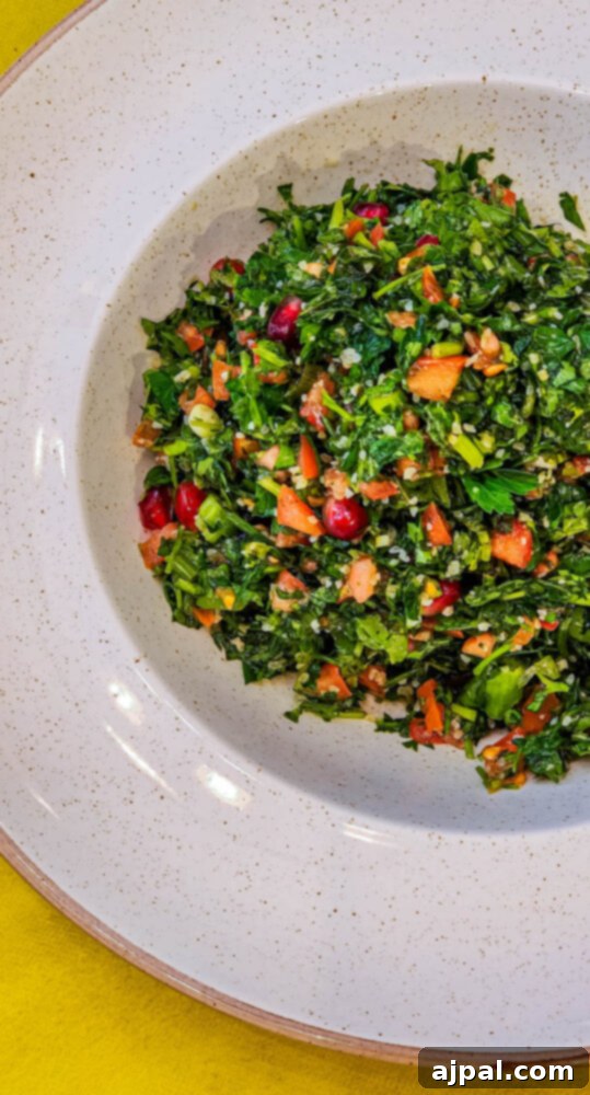 A vibrant tabbouleh salad, brimming with fresh parsley, mint, tomatoes, and bulgur, presented in a rustic bowl.