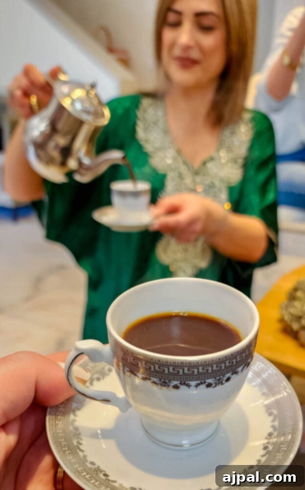 A woman elegantly pouring aromatic Arabic coffee, with a close-up of a hand holding a cup, symbolizing hospitality and tradition.