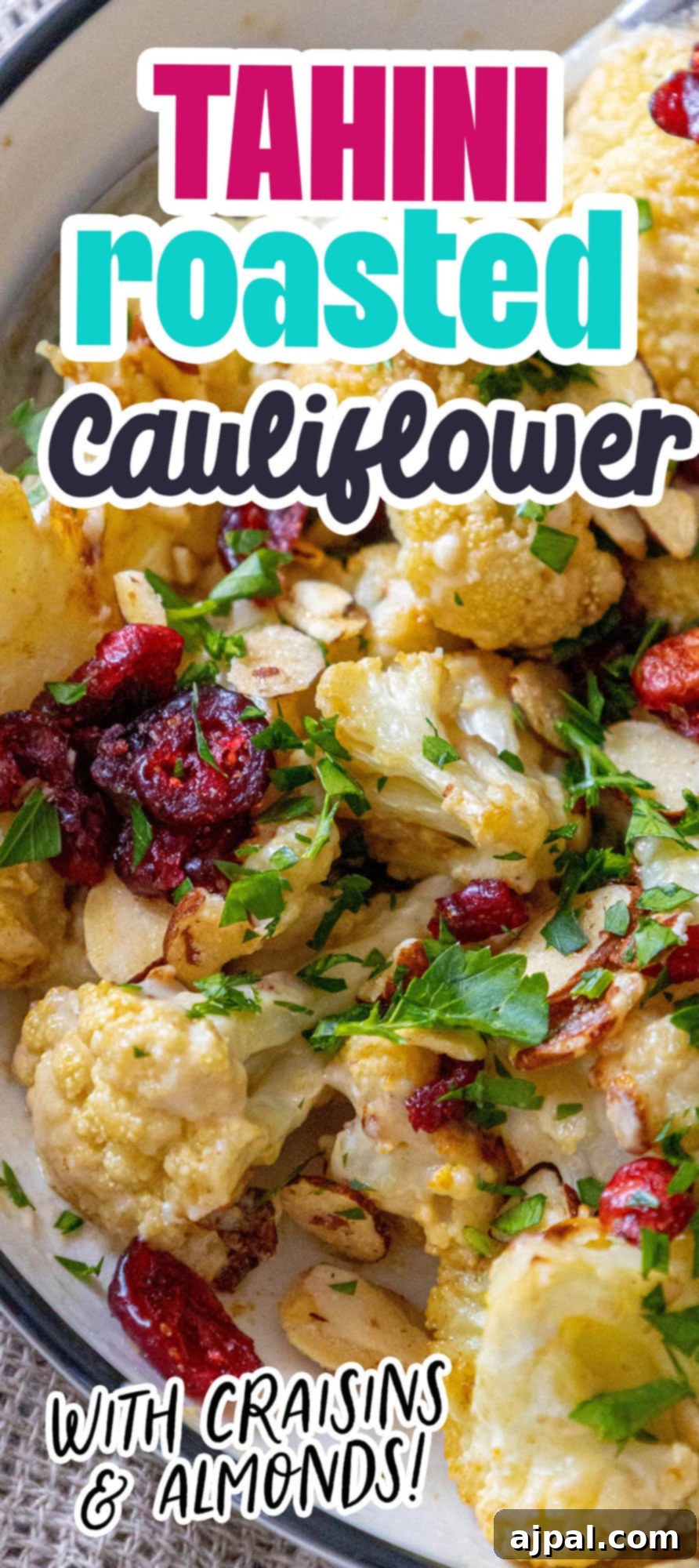 A stunning vertical shot of tahini roasted cauliflower with cranberries and almonds, perfect for highlighting on social media or in a cookbook.