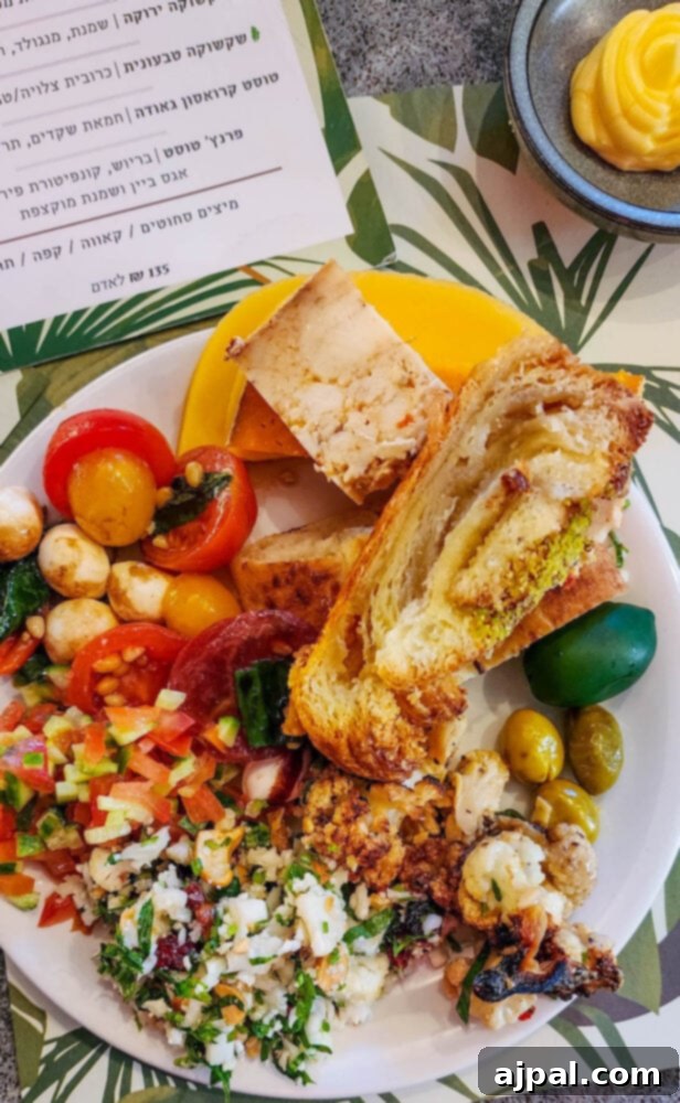 A diverse breakfast platter featuring tahini roasted cauliflower alongside various fresh ingredients.