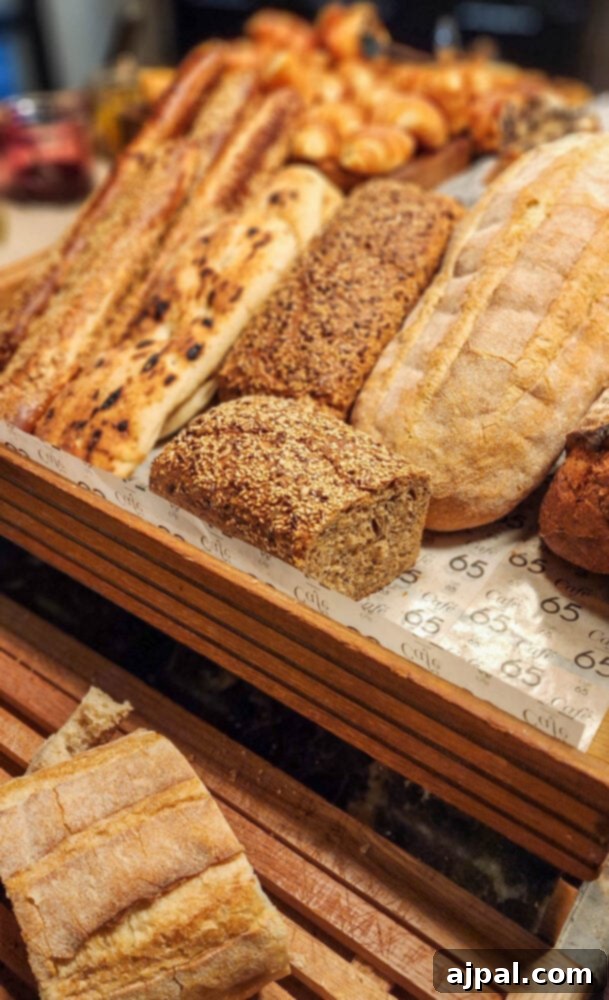 An appetizing spread of Israeli breakfast items, including freshly baked breads and a bowl of tahini roasted cauliflower.