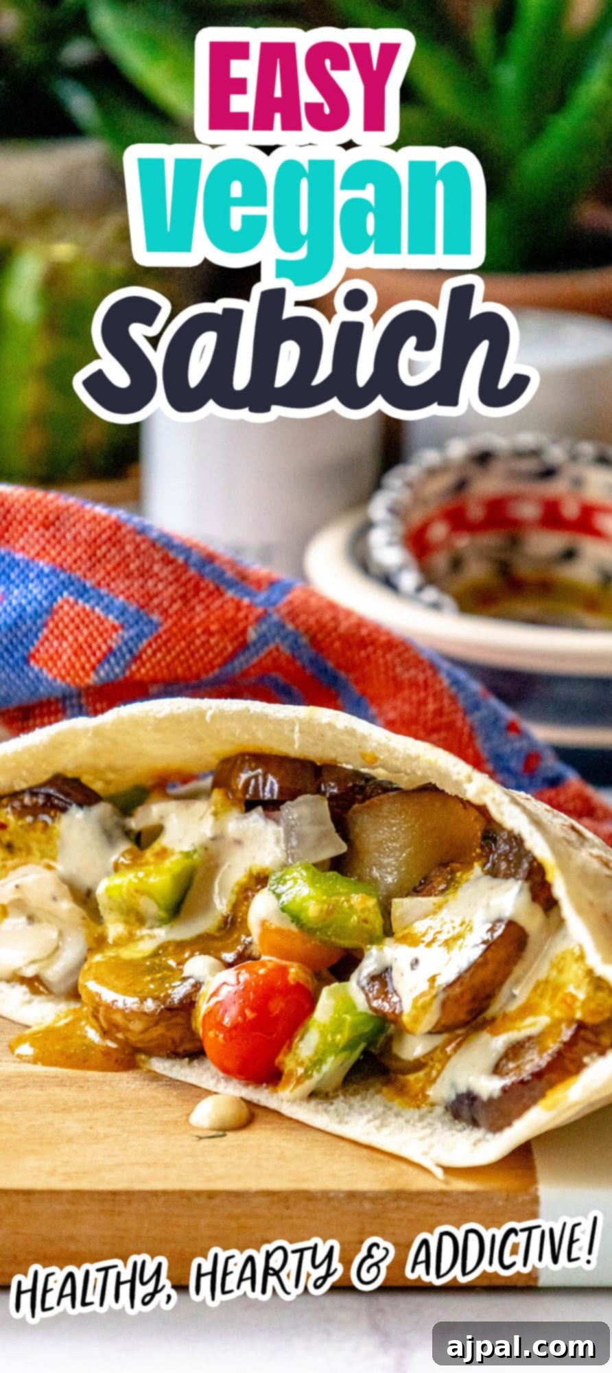 sabich sandwich with fried eggplants, fried mushrooms, Israeli salad, amba sauce, tahini sauce and hummus in a pita